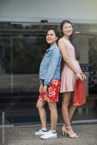 young asian friends shopping spree at shopping mall