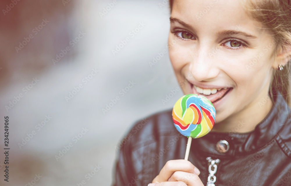 Beautiful little girl with candy, outdoor