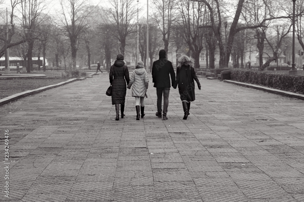 Friends walking through Latvian Park