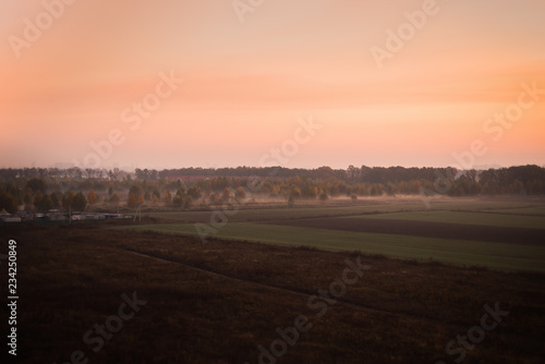 Foggy pink sunset above the plains