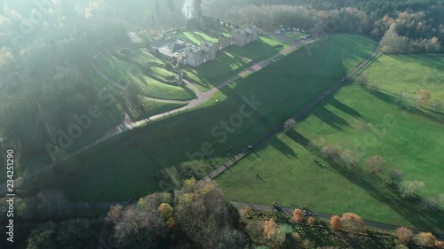 Aerial footage over Chatelherault hunting lodge on an early hazy winters day with a low sun throwing long shadows. photo