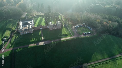 Aerial footage over Chatelherault hunting lodge on an early hazy winters day with a low sun throwing long shadows. photo