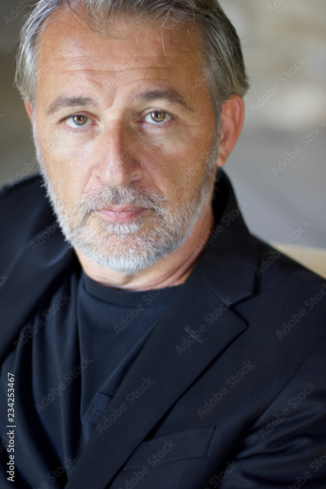 Fototapeta premium close portrait of adult handsome man in blue jacket, vertical.