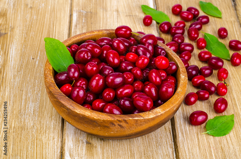 Autumn ripe cornel berries on wooden table Autumn ripe cornel berries on wooden table