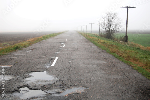 An old rural road on a gray rainy autumn day