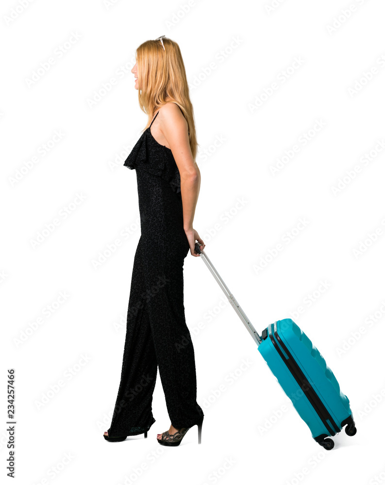 blond girl traveling with her suitcase walking on isolated white backgroun blond girl traveling with her suitcase walking on isolated white backgroun