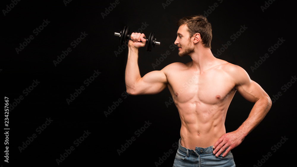 european caucasian athletic man bodybuilder holding dumbell and showing his muscular arms