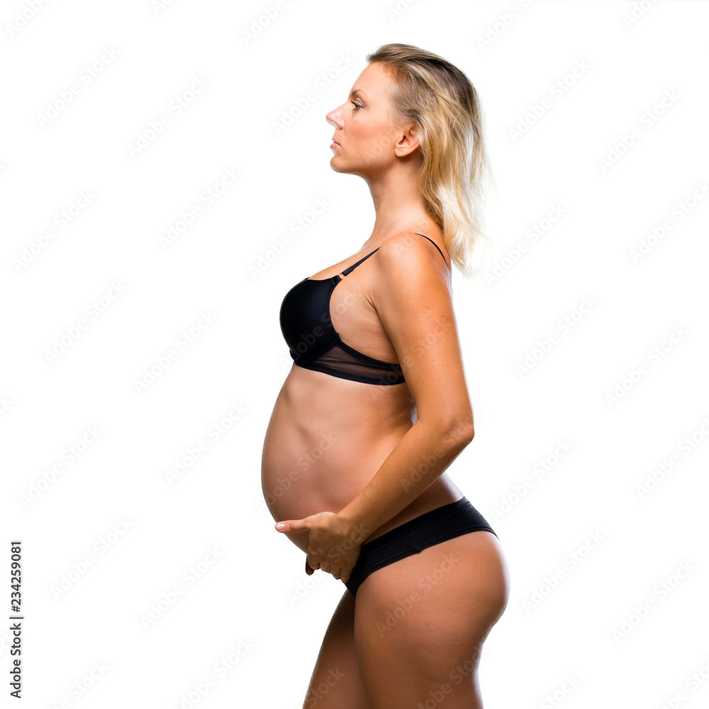 Fototapeta premium Blonde pregnant woman in underwear on isolated white background