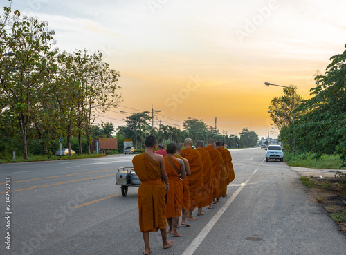 monk are doing receiving food from Buddhist in the early morning in Thailand photo