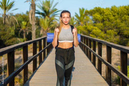 Young sport woman doing exercise in the park © luismolinero