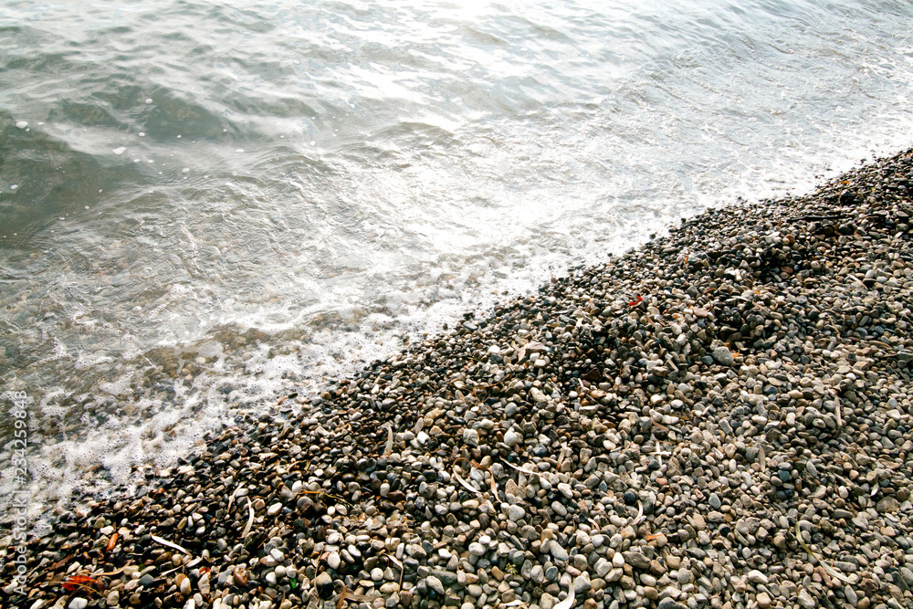 surface of small stones and sea water