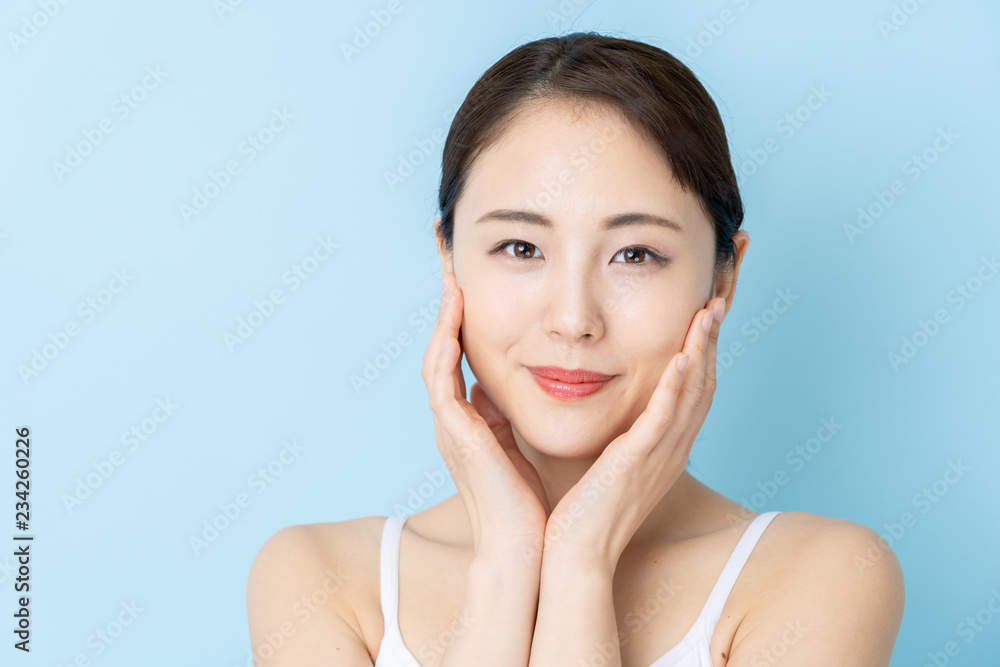 attractive asian woman beauty image on blue background attractive asian woman beauty image on blue background
