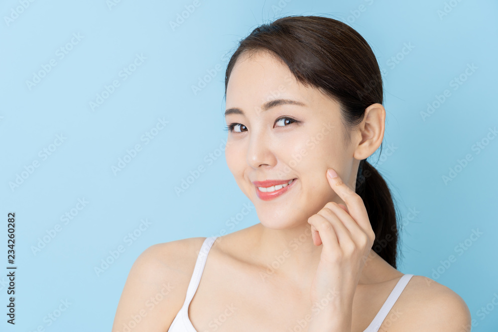 attractive asian woman beauty image on blue background attractive asian woman beauty image on blue background