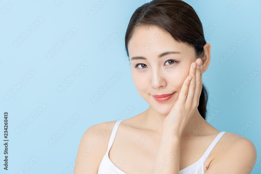 attractive asian woman beauty image on blue background attractive asian woman beauty image on blue background