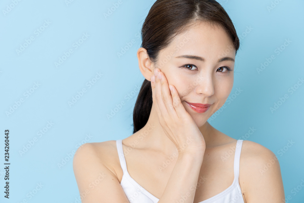 attractive asian woman beauty image on blue background attractive asian woman beauty image on blue background