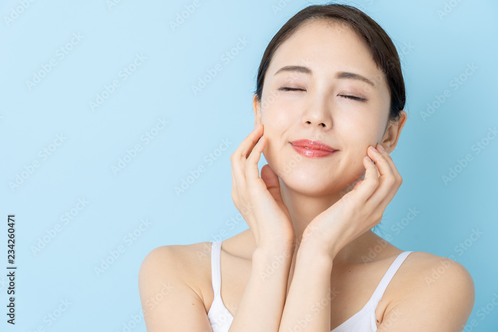 attractive asian woman beauty image on blue background attractive asian woman beauty image on blue background
