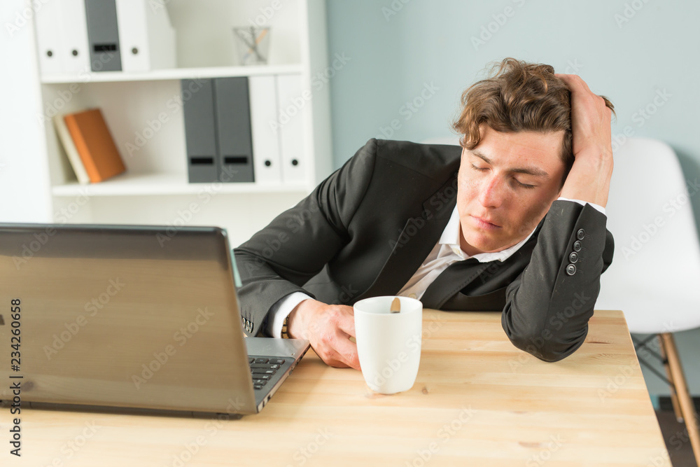 Joke, business people and humor concept - Tired businessman sleeping after hard working day in office interior. Man lying on table with laptop computer on. Joke, business people and humor concept - Tired businessman sleeping after hard working day in office interior. Man lying on table with laptop computer on.