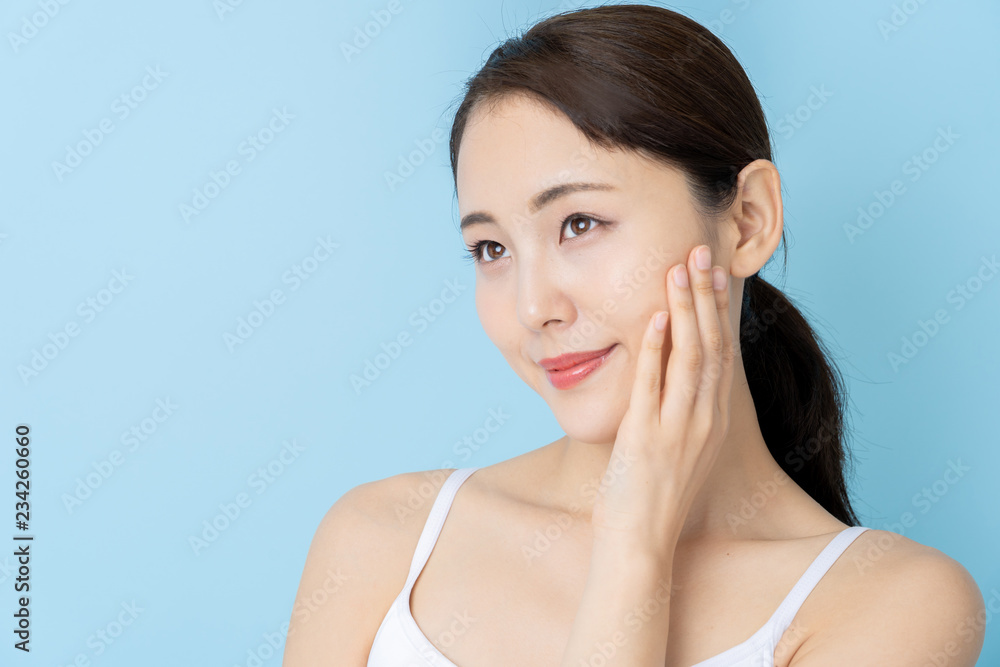 attractive asian woman beauty image on blue background attractive asian woman beauty image on blue background