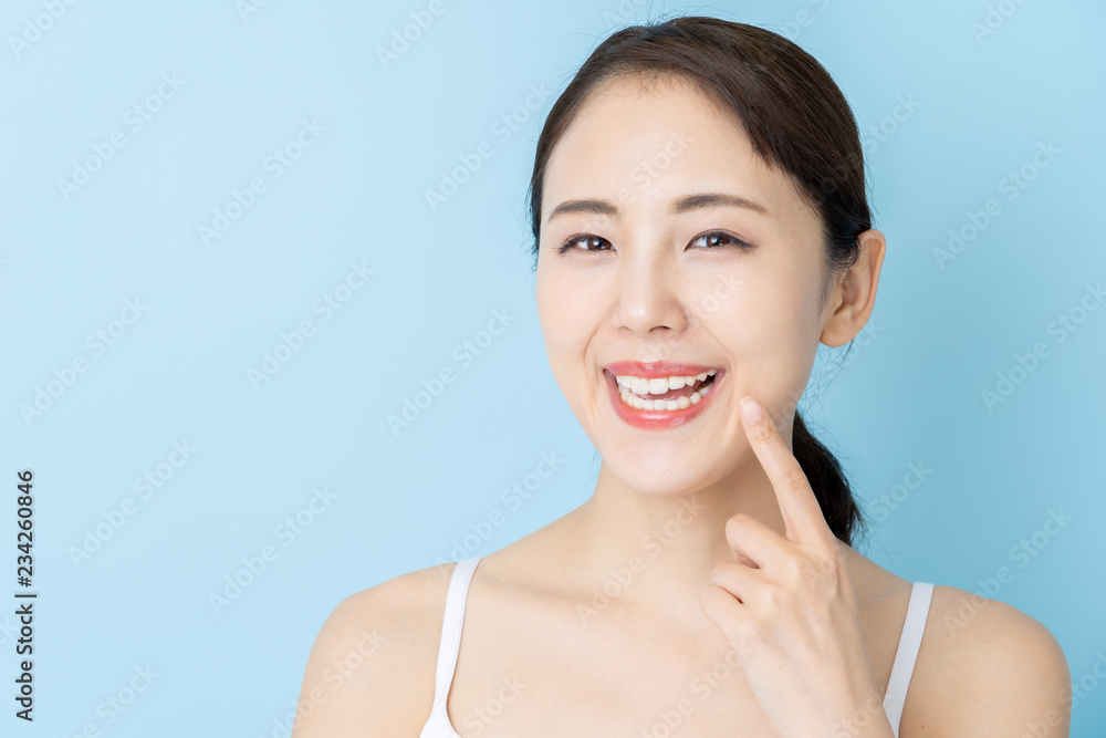 attractive asian woman beauty image on blue background attractive asian woman beauty image on blue background