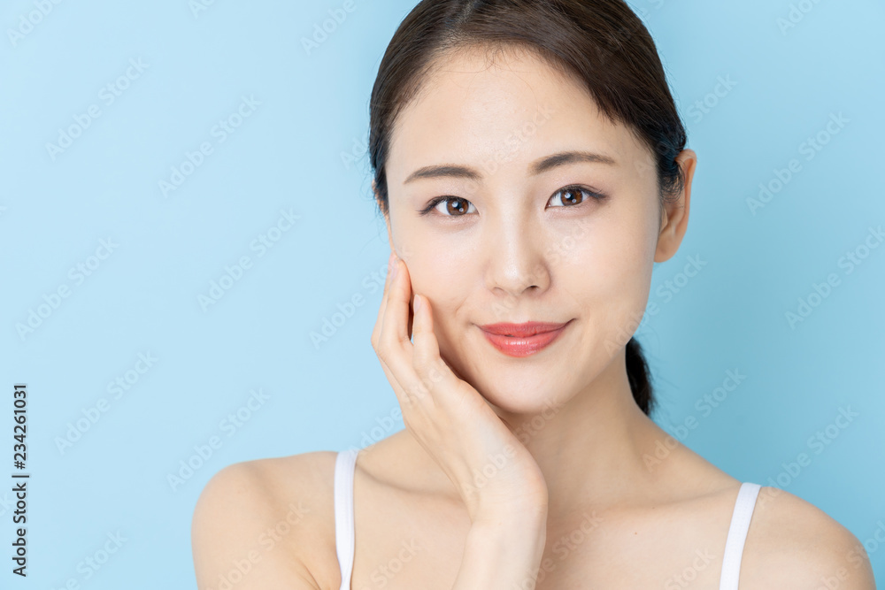 attractive asian woman beauty image on blue background attractive asian woman beauty image on blue background