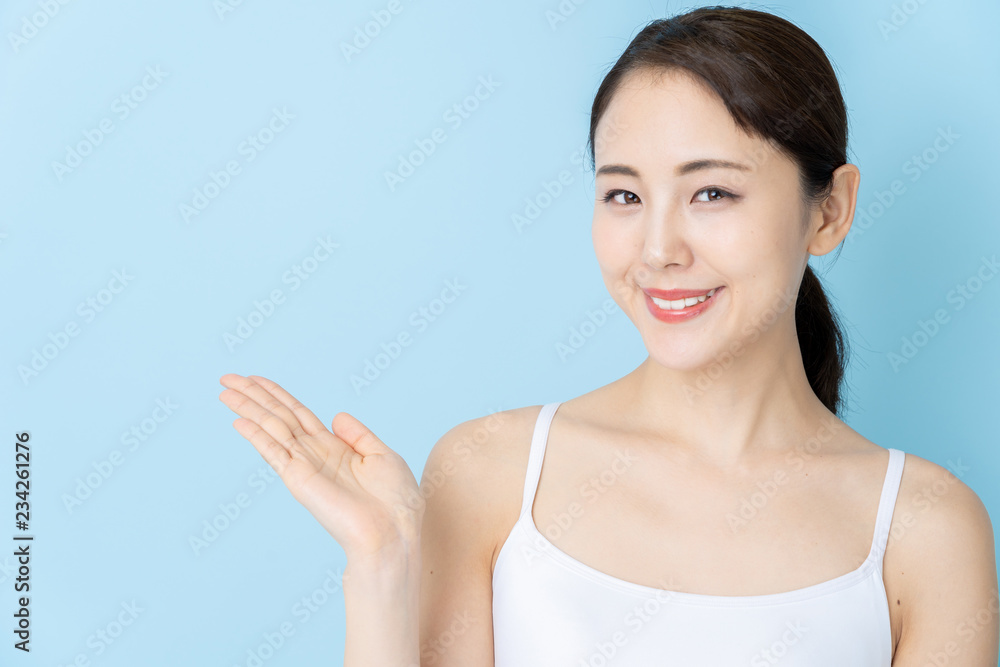 attractive asian woman beauty image on blue background attractive asian woman beauty image on blue background