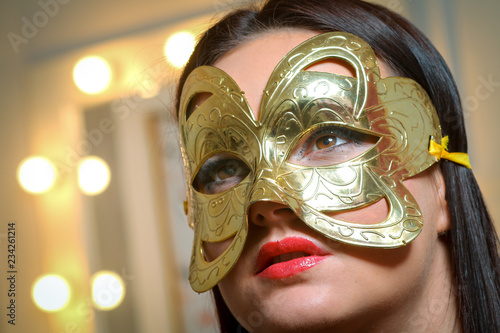 Beauty model woman wearing masquerade carnival mask over Christmas and New Year celebration holiday party © tcsaba