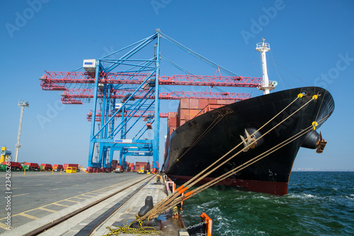 Container ship in port at container terminal. Ships of container ships stand in terminal of port on loading, unloading container.
