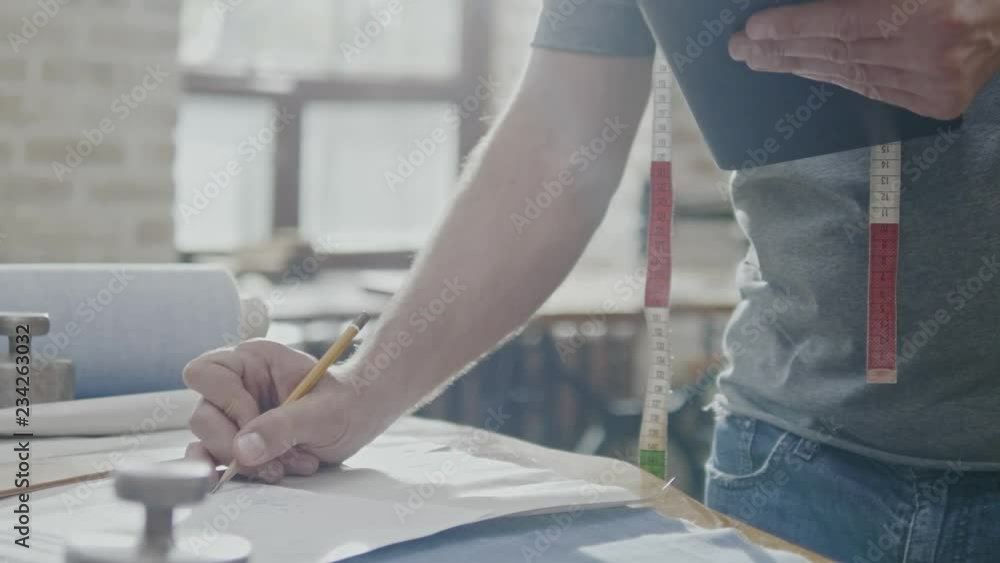 Fashion designer working in his studio Fashion designer working in his studio