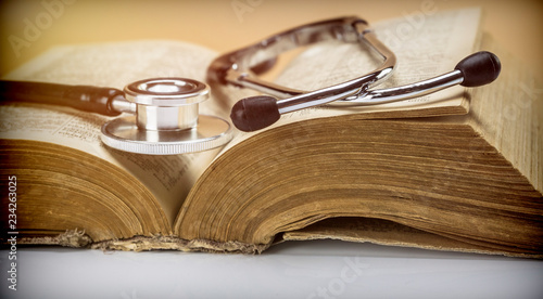 Stethoscope on an old medical book, concept image