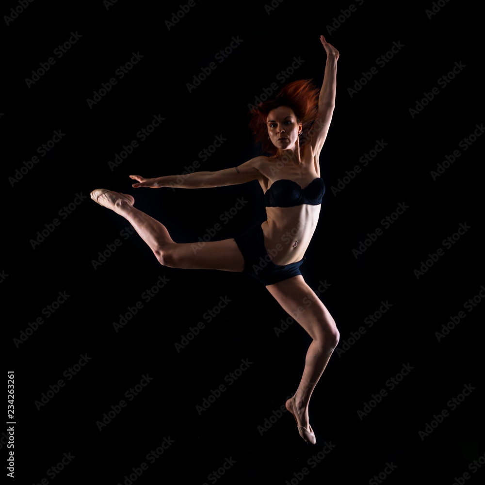 Redhead Girl doing ballet in studio and jumping
