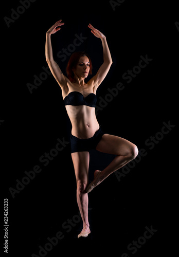 Redhead Girl doing ballet in studio