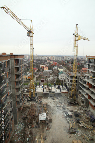 Construction of a residential multi-storey building. Working crane on the construction of the house