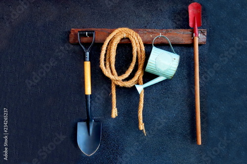 Garden tools hanging on the black wall