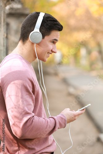 Young man listening to musi...