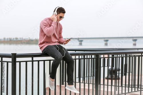 Young man listening to musi...