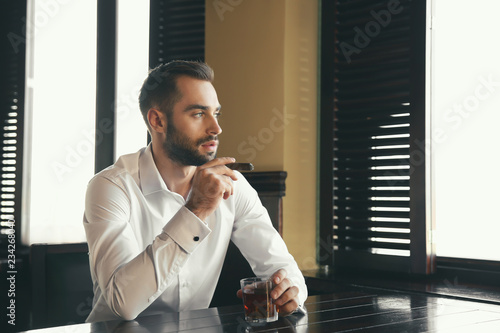 Young man with glass of whi...