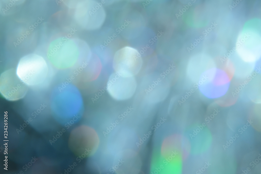 Obraz premium Bokeh photo. Holiday background. Christmas lights. background. Defocused sparkles. New Year backdrop. Festive wallpaper. Blinks. Carnival. Retro style photo. Holographic.