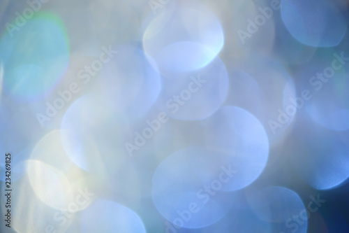 Bokeh photo. Holiday background. Christmas lights. background. Defocused sparkles. New Year backdrop. Festive wallpaper. Blinks. Carnival. Retro style photo. Holographic.