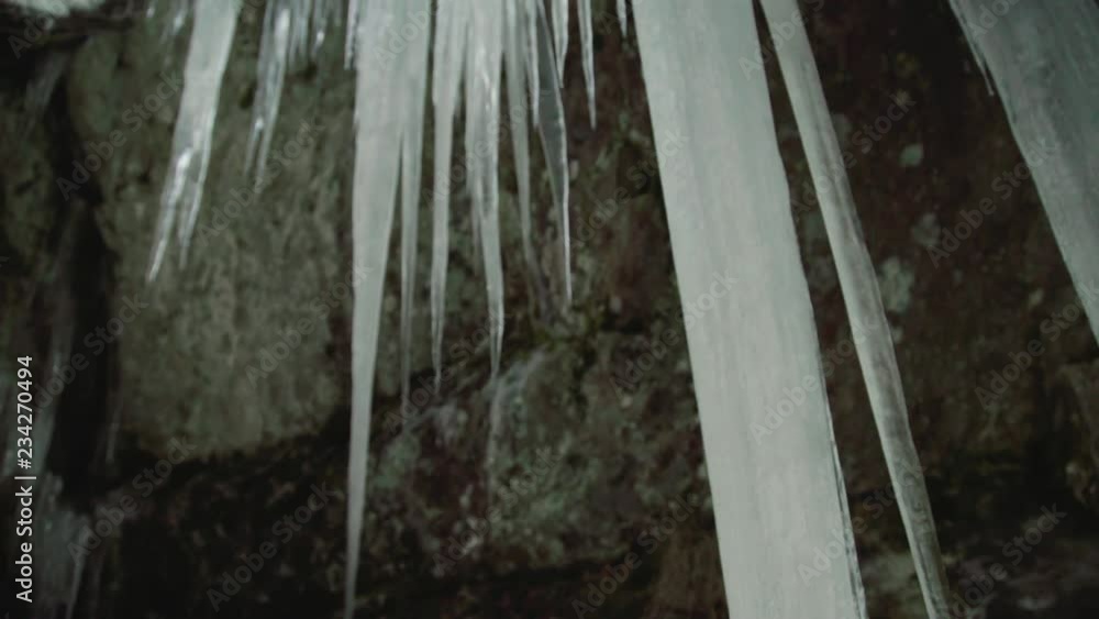 Huge melting icicle sculpture by nature in the norwegian forest Huge melting icicle sculpture by nature in the norwegian forest