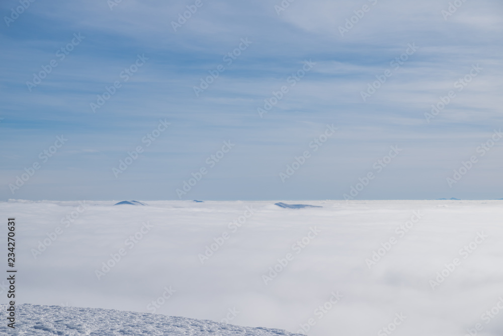 Above white heavy clouds. Panorama of cloudscape from the top of the mountain.