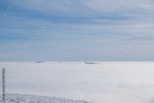Above white heavy clouds. Panorama of cloudscape from the top of the mountain. © volff