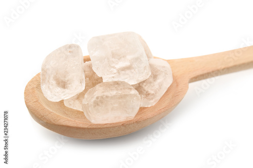 Wooden spoon with sugar on white background