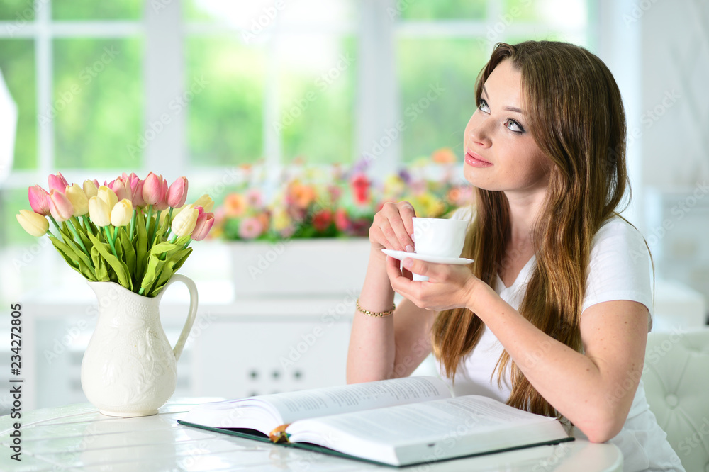 Beautiful young woman sitting with opened book Beautiful young woman sitting with opened book