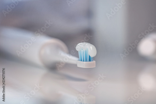 Closeup shot of electronic toothbrush with toothpaste