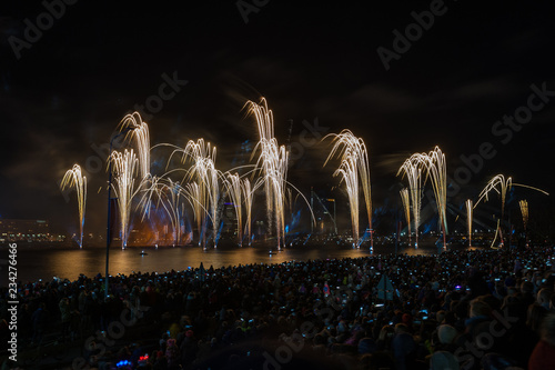 Latvian Independence Day celebrations with Saules Mūžs fireworks presentation. Riga, Latvia. Thousands of people line the River Daugava for a fireworks display timed. photo