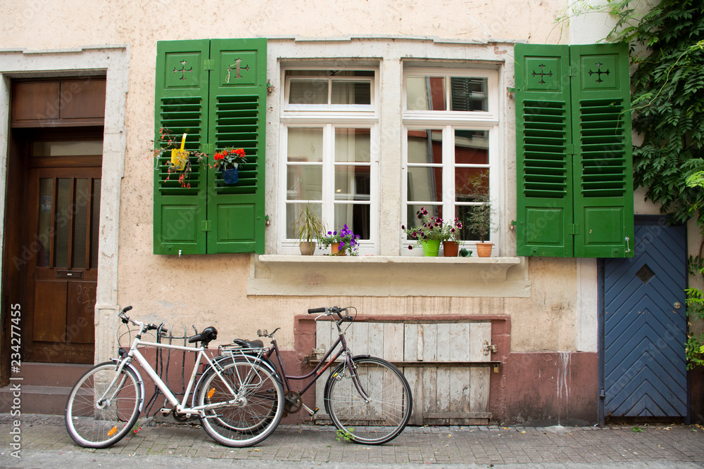 German people stopping and lock bicycle at front of classic and retro house in Heidelberg, Germany