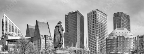 Panorama photo of the statue of William vam Orange on het Plein in the Hague with the sky-line in the background in black and white photo