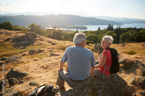 Senior Couple Resting At Top Of Hill On Hike Through Countryside In Lake Distric фототапет