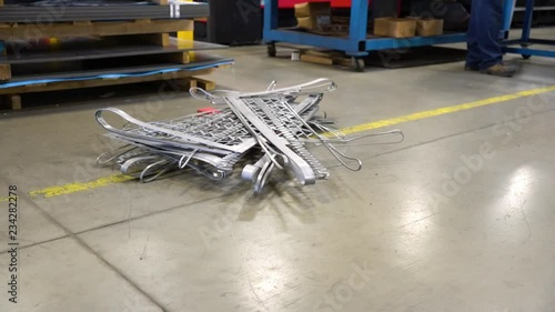 An employee trips on a hazard in an industrial manufacturing factory.