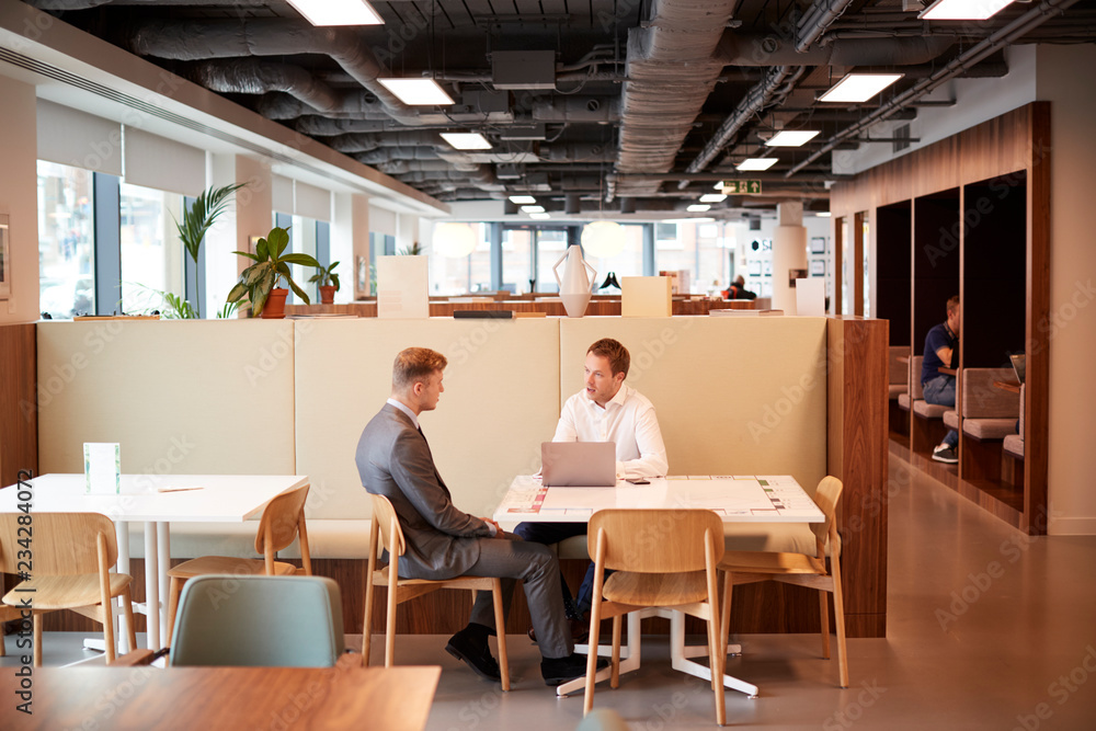 Young Businessman Having Informal Interview In Cafeteria Area At Graduate Recruitment Assessment Day Young Businessman Having Informal Interview In Cafeteria Area At Graduate Recruitment Assessment Day